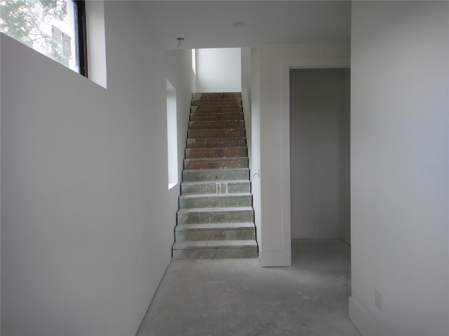 stairway featuring concrete floors