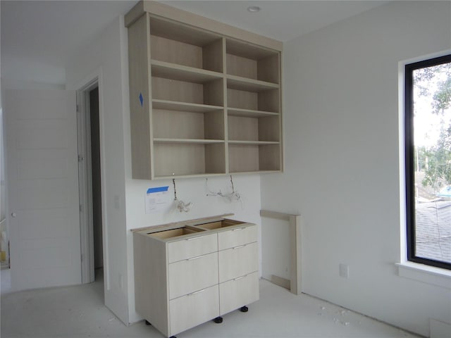 unfurnished office featuring a sink and concrete floors