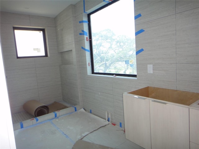 full bathroom with tile walls