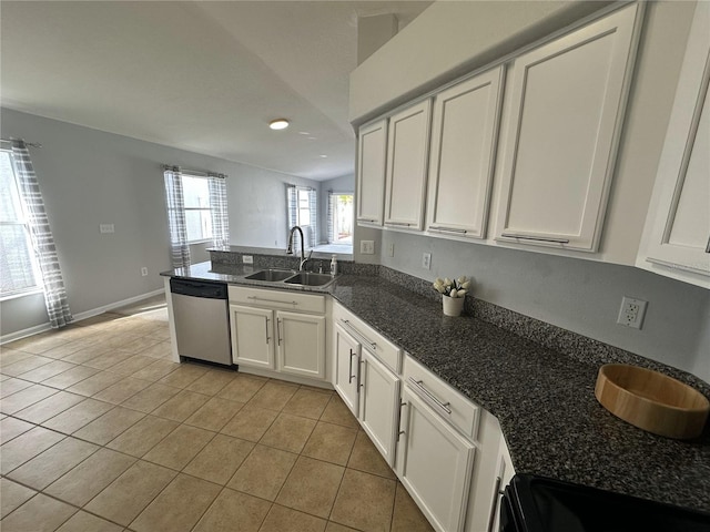 25830 Crippen Dr, Land O Lakes, FL 34639 - kitchen with stainless steel dishwasher, light tile patterned floors, a peninsula, white cabinets, and recessed lighting