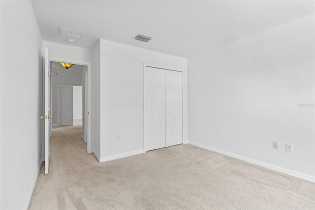 25830 Crippen Dr, Land O Lakes, FL 34639 - unfurnished bedroom featuring light carpet and a closet