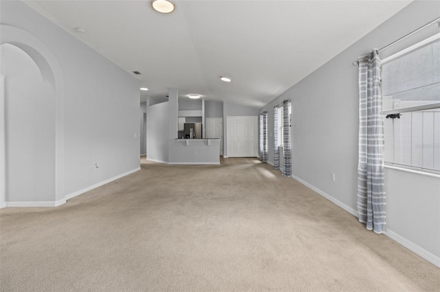 25830 Crippen Dr, Land O Lakes, FL 34639 - unfurnished living room with carpet floors, recessed lighting, arched walkways, and vaulted ceiling