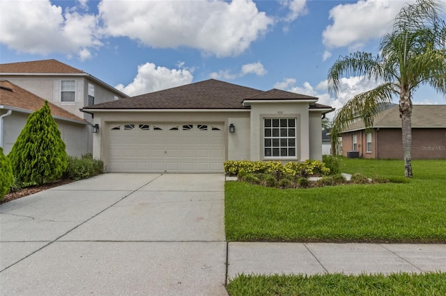 25830 Crippen Dr, Land O Lakes, FL 34639 - view of front of house featuring a garage, stucco siding, driveway, a front yard, and a shingled roof