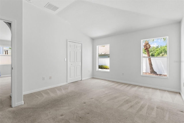 25830 Crippen Dr, Land O Lakes, FL 34639 - unfurnished bedroom with carpet, arched walkways, and lofted ceiling