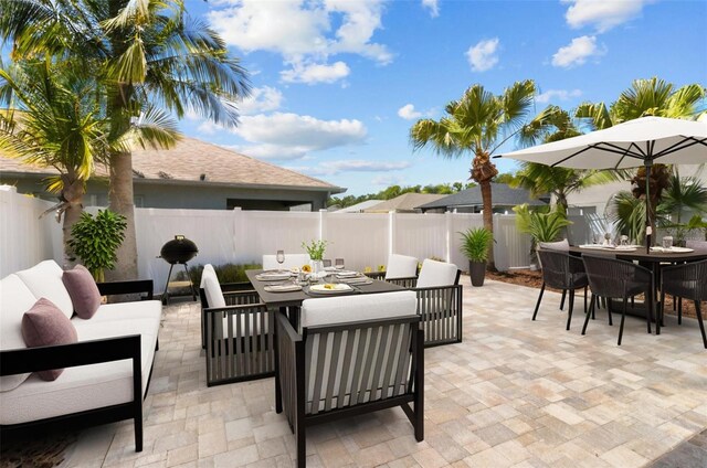 25830 Crippen Dr, Land O Lakes, FL 34639 - fenced backyard featuring outdoor dining space, a patio, and an outdoor living space