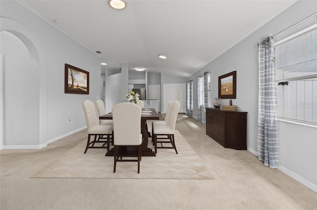 25830 Crippen Dr, Land O Lakes, FL 34639 - dining space with light carpet, recessed lighting, lofted ceiling, and arched walkways