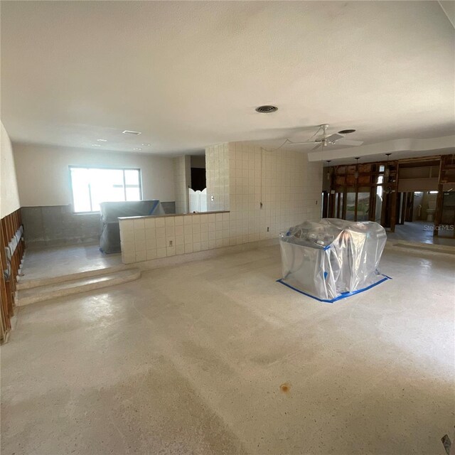 2015 Dolphin Blvd S, Saint Petersburg, FL 33707 - unfurnished living room featuring a wainscoted wall