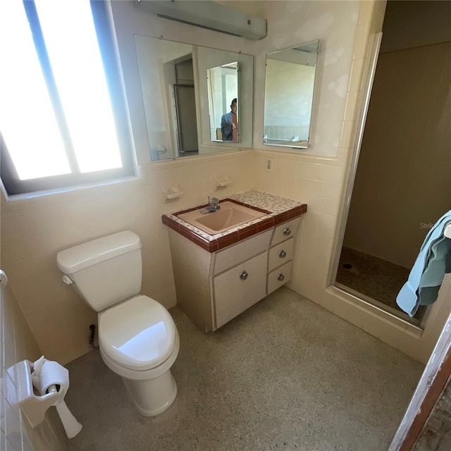 2015 Dolphin Blvd S, Saint Petersburg, FL 33707 - bathroom with vanity, tile walls, a shower stall, and toilet