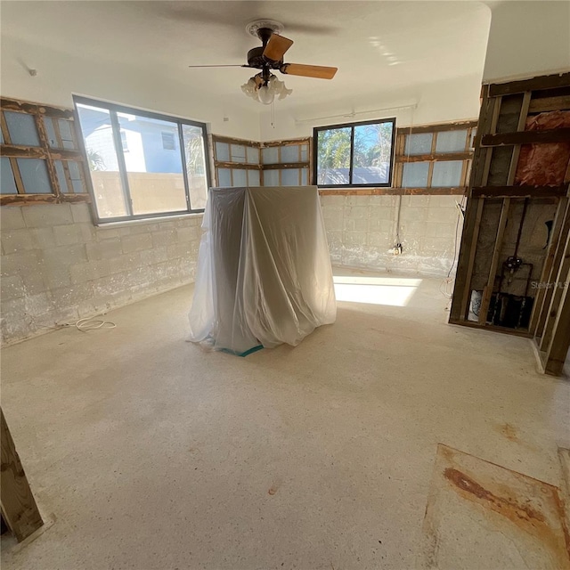 2015 Dolphin Blvd S, Saint Petersburg, FL 33707 - interior space with concrete block wall and ceiling fan