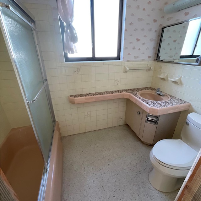 2015 Dolphin Blvd S, Saint Petersburg, FL 33707 - full bathroom with vanity, tile walls, a shower with door, and toilet
