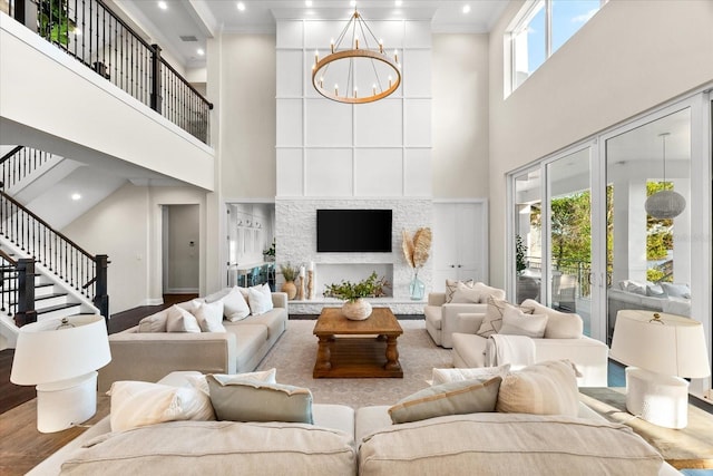 885 Seaview Cir Unit 20, Crystal Beach, FL 34681 - living room featuring a towering ceiling, stairway, a chandelier, wood finished floors, and recessed lighting