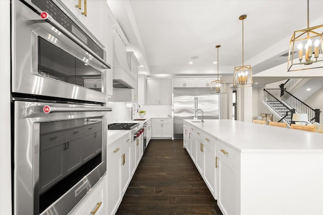 885 Seaview Cir Unit 20, Crystal Beach, FL 34681 - kitchen with a chandelier, appliances with stainless steel finishes, dark wood-style flooring, a sink, and white cabinetry