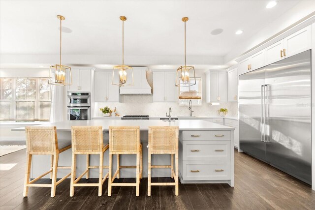 885 Seaview Cir Unit 20, Crystal Beach, FL 34681 - kitchen with appliances with stainless steel finishes, custom range hood, a sink, light countertops, and recessed lighting