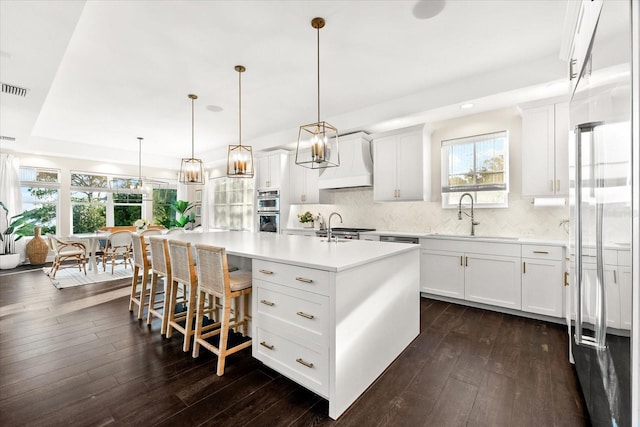885 Seaview Cir Unit 20, Crystal Beach, FL 34681 - kitchen featuring premium range hood, a sink, dark wood-style floors, light countertops, and recessed lighting