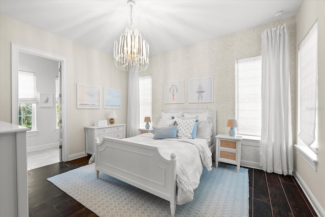 885 Seaview Cir Unit 20, Crystal Beach, FL 34681 - bedroom featuring a chandelier, dark wood-style floors, baseboards, and wallpapered walls