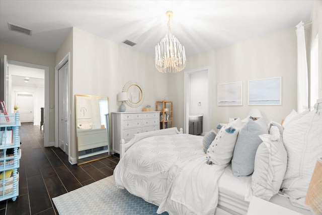 885 Seaview Cir Unit 20, Crystal Beach, FL 34681 - bedroom featuring a chandelier, dark wood-style floors, ensuite bathroom, and baseboards