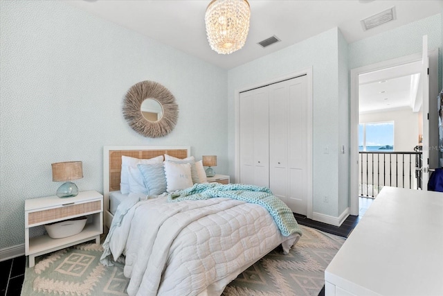 885 Seaview Cir Unit 20, Crystal Beach, FL 34681 - bedroom with baseboards, wood finished floors, a closet, and a chandelier