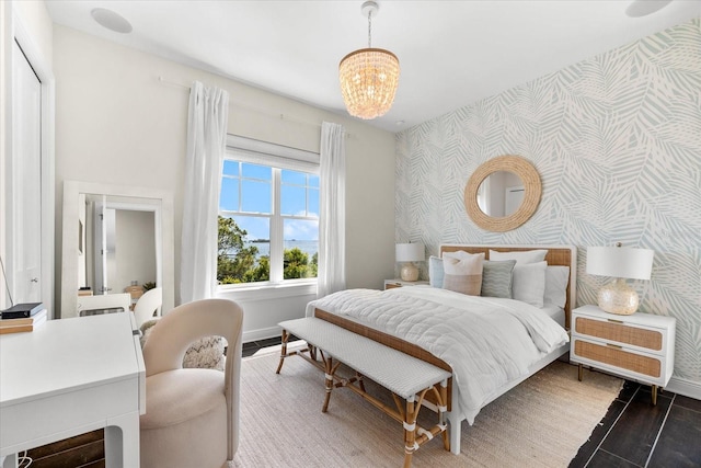885 Seaview Cir Unit 20, Crystal Beach, FL 34681 - bedroom with wallpapered walls, an accent wall, a chandelier, and baseboards