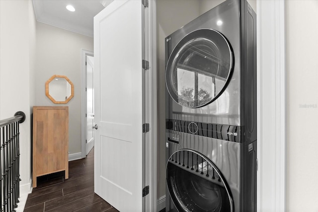 885 Seaview Cir Unit 20, Crystal Beach, FL 34681 - washroom featuring stacked washer and clothes dryer, ornamental molding, dark wood-style flooring, baseboards, and recessed lighting
