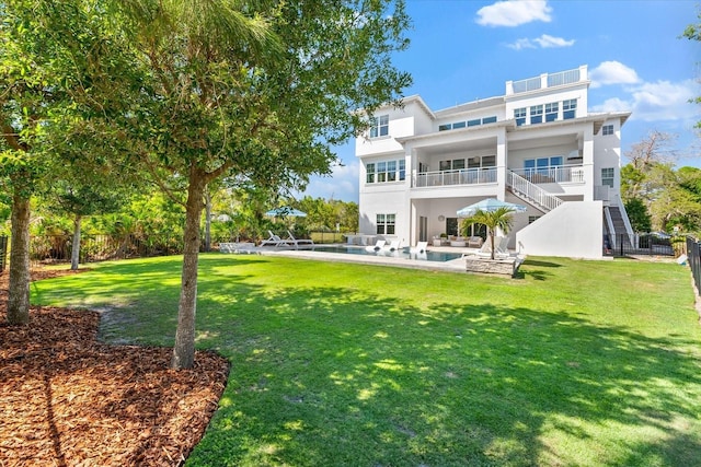 885 Seaview Cir Unit 20, Crystal Beach, FL 34681 - rear view of house featuring a balcony, stairway, a pool, stucco siding, and outdoor lounge area
