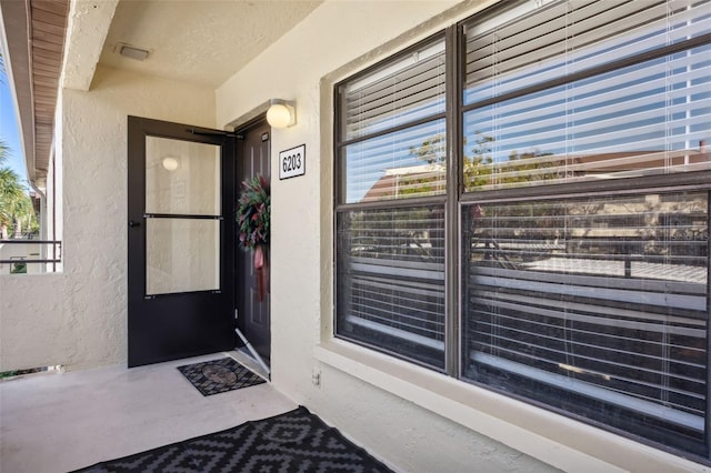 doorway to property with stucco siding