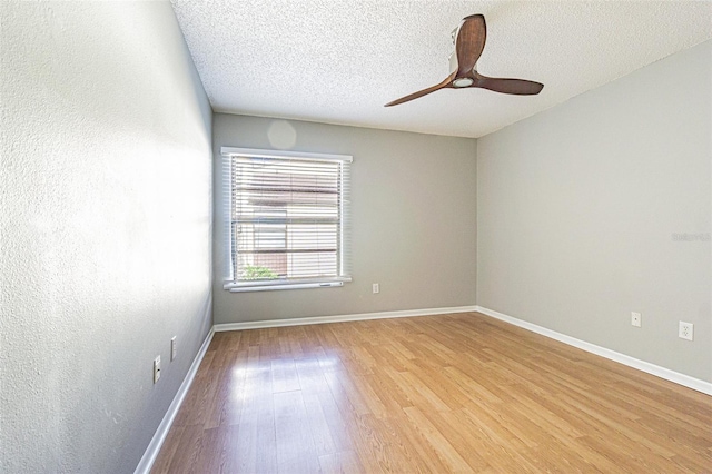 unfurnished room with baseboards, a textured ceiling, light wood finished floors, and ceiling fan