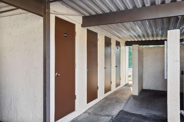 doorway to property featuring stucco siding