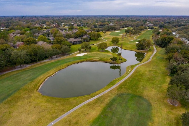 birds eye view of property with a water view and view of golf course