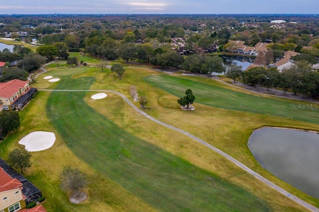 birds eye view of property with view of golf course and a water view