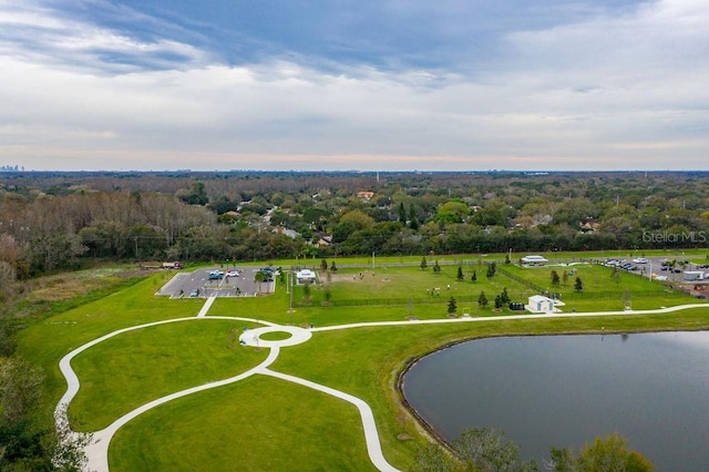 drone / aerial view with a water view and a forest view