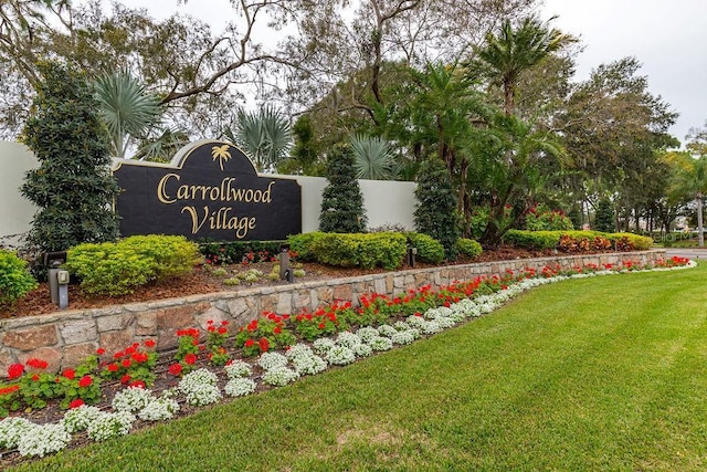 community / neighborhood sign with a lawn