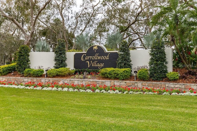 community / neighborhood sign featuring a lawn