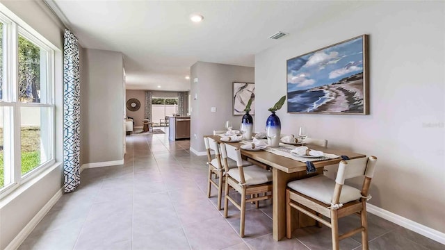 dining room with baseboards, a wealth of natural light, and visible vents