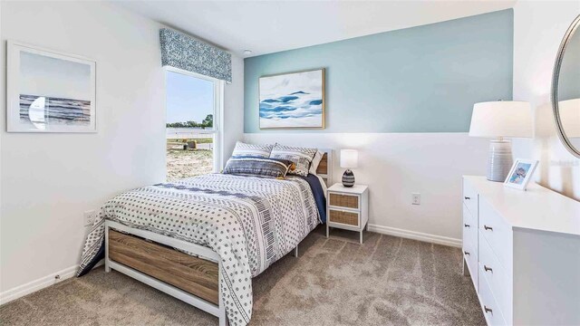 bedroom featuring baseboards and light colored carpet