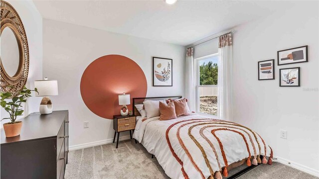bedroom featuring baseboards and light colored carpet