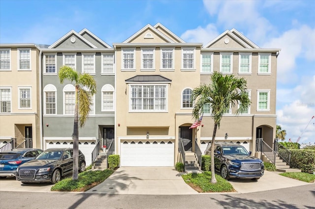 1476 Harbour Walk Rd, Tampa, FL 33602 - townhome / multi-family property with an attached garage, driveway, and stucco siding