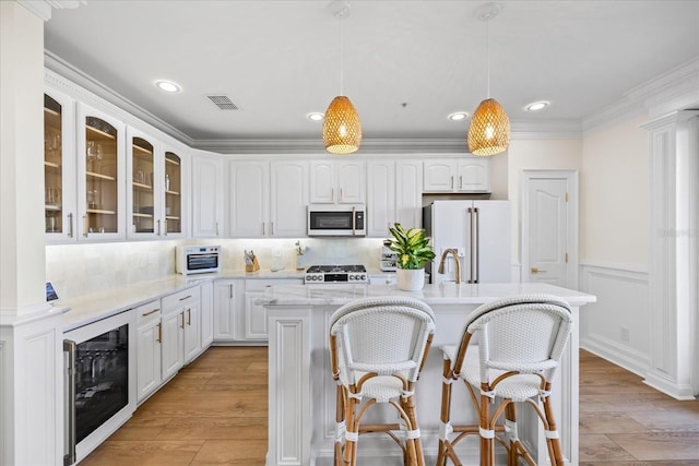 1476 Harbour Walk Rd, Tampa, FL 33602 - kitchen featuring white appliances, beverage cooler, glass insert cabinets, pendant lighting, and light wood-type flooring