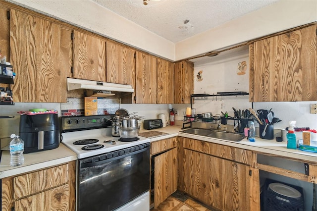 kitchen with brown cabinetry, range with electric cooktop, a textured ceiling, a sink, and under cabinet range hood
