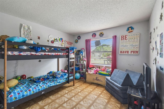 bedroom with light floors and a textured ceiling