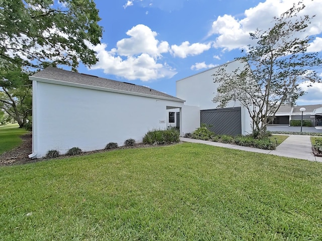 view of property exterior with a lawn and stucco siding