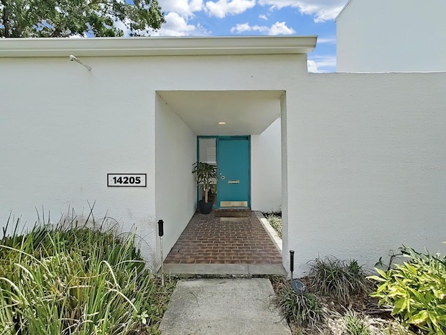 doorway to property with stucco siding
