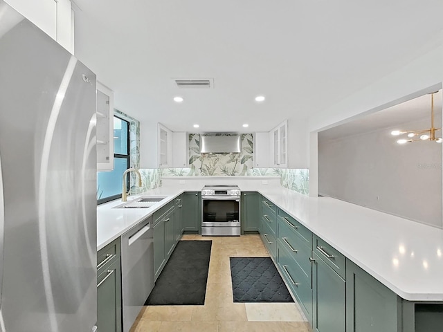 kitchen featuring light countertops, green cabinetry, appliances with stainless steel finishes, and visible vents