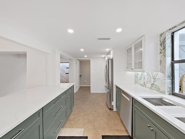 kitchen featuring light countertops, stainless steel appliances, white cabinets, and visible vents