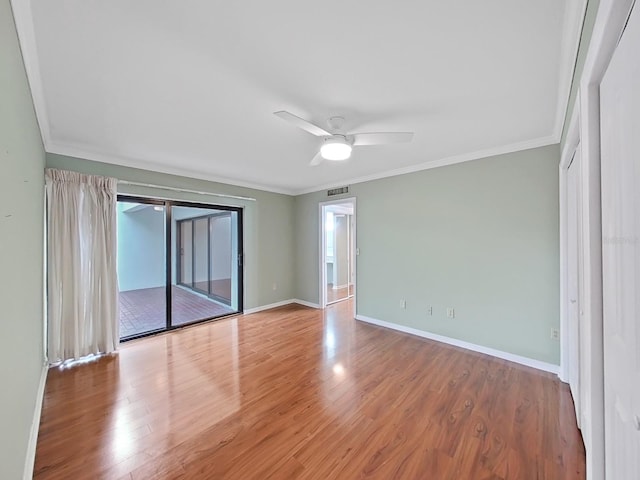 unfurnished room with ornamental molding, ceiling fan, and wood finished floors