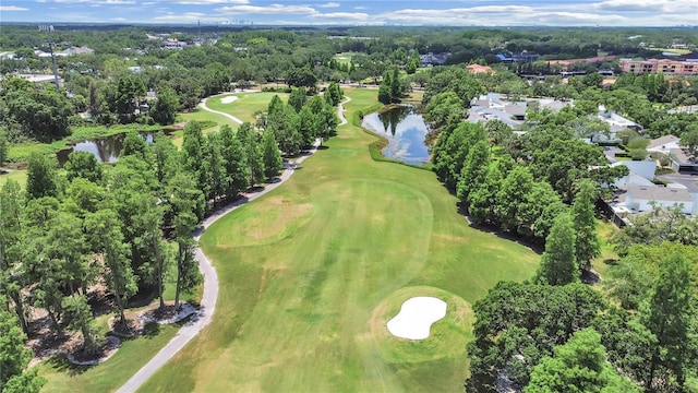 drone / aerial view featuring view of golf course and a water view