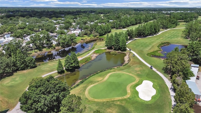 birds eye view of property with view of golf course and a water view