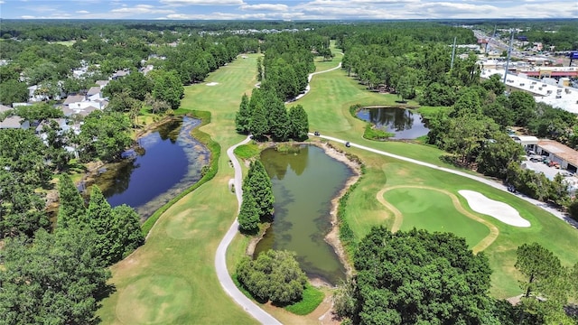drone / aerial view featuring view of golf course and a water view
