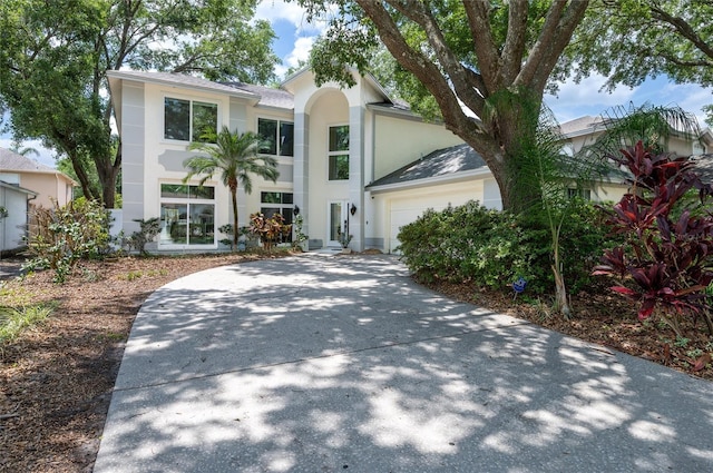 view of front of home featuring a garage, stucco siding, and concrete driveway