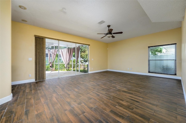 spare room featuring visible vents, baseboards, ceiling fan, and wood finished floors