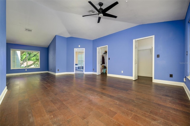 interior space with wood-type flooring, visible vents, and vaulted ceiling